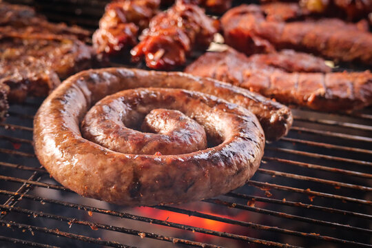 grilled sausages on the grill. South African braai with boerewors sausage. 