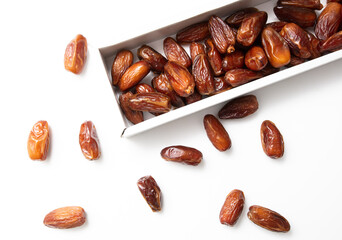 Dried dates in a box isolated on a white background.