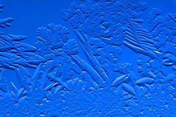 Drawings of ice on blue glass.