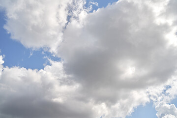 Backdrop of a white cloud in a blue summer sky. Natural background with soft clouds.