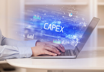 Closeup of businessman hands working on laptop