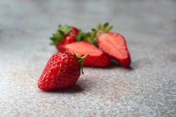 Fresh ripe delicious strawberries on the table on an abstract background
