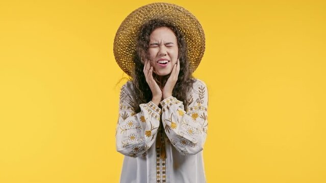 Pretty ukrainian woman shows triumph yes yeah gesture of victory, achieved result, goals. Girl glad, happy, surprised excited happy lady on yellow background. Victory concept.