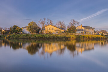 Suburban Home Illuminated in Yellow Golden Hour Glow in the Morning