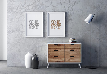 Two vertical poster Frames Mockup hanging above wooden chest 