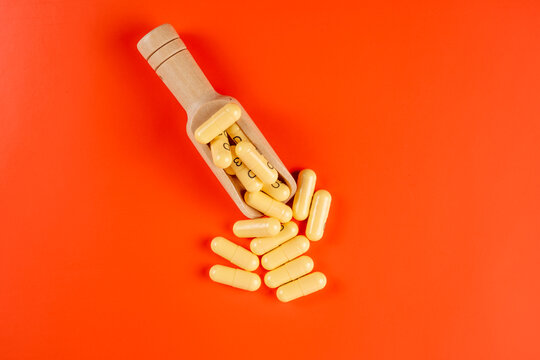 medicinal prescribed pharmaceutical controlled drugs hard capsules isolated on an orange background