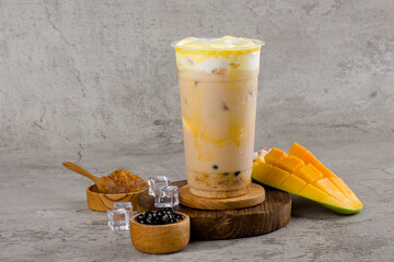 Boba or tapioca pearls is taiwan bubble milk tea in plastic cup with mango caramel flavor on...