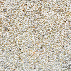 The pattern yellowish white white pebbles stone as background. pebbles texture wall and floor.