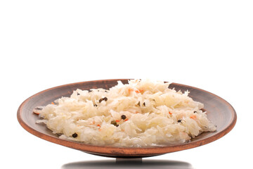 Sauerkraut in a clay plate, macro, isolated on white background.