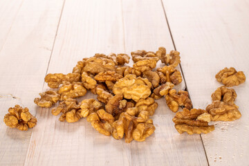Several peeled walnuts on a wooden table, macro.