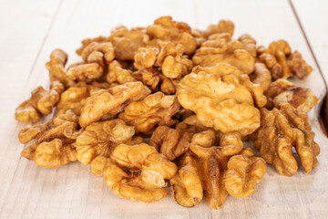 Several peeled walnuts on a wooden table, macro.