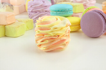 Various of sweets: macaroons, marshmallows and zephyrs. Delicate colored desserts for the present.