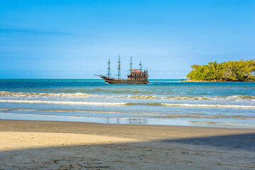 pirate boat sailing near the coast or beach, atlantic ocean