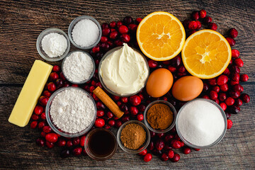 Spiced Mascarpone Cranberry Cake Ingredients on a Wood Table: Fresh cranberries, mascarpone cheese, and other uncooked cake ingredients