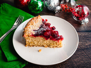 Sliced Piece of Spiced Mascarpone Cranberry Cake on a Plate: Single layer cake spiced with cinnamon and nutmeg topped with cranberry sauce