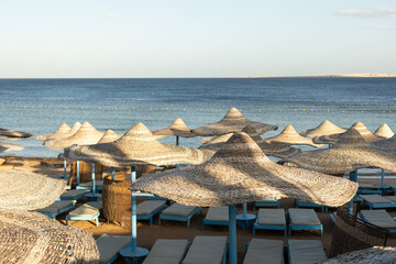 straw beach umbrella with blue sky.