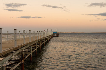 Golden sea sunset on the wooden pier.