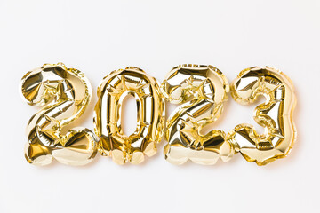 New year 2023 balloon celebration card. Gold foil helium balloon number 2023 isolated on white...