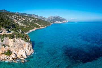 Fototapeta na wymiar the rugged mountainous coast near Cala Gonone with turqouise water and small white sand beaches