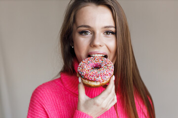 pretty young woman with donut in studio  - 552842587