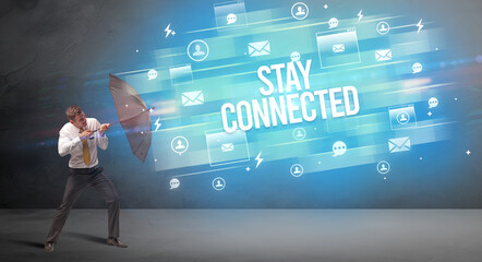 businessman defending with umbrella concept