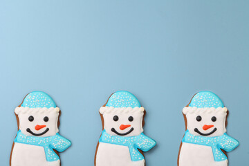 snowman gingerbread on blue background. Christmas cookie pattern. Blue seamless Winter holidays