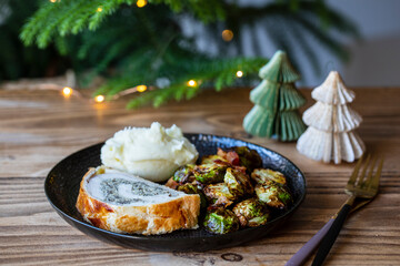 Christmas dinner with chicken Wellington, mash potatoes and roasted brussel sprouts