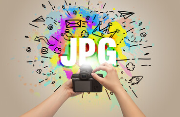 Close-up of a hand holding digital camera with abstract drawing