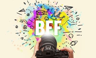 Close-up of a hand holding digital camera with abstract drawing