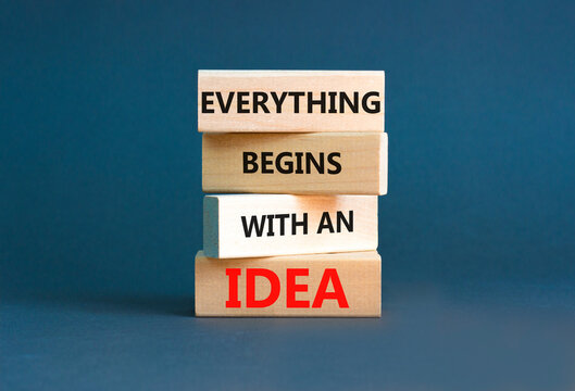 Everything begins with an idea symbol. Concept word Everything begins with an idea on wooden blocks. Beautiful grey table grey background. Business everything begins with an idea concept. Copy space.