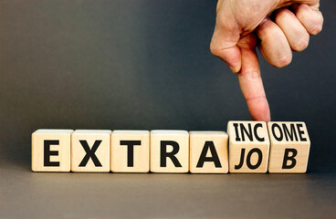 Extra job and income symbol. Concept words Extra job Extra income on wooden cubes. Businessman...