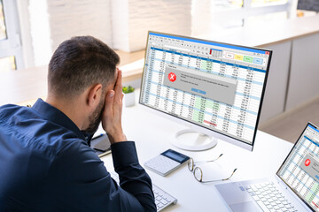 Obraz na płótnie Canvas Worried Man At Computer With System Failure Screen