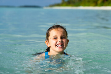 Kid Learning Swimming With Swimming Disc Or Ring