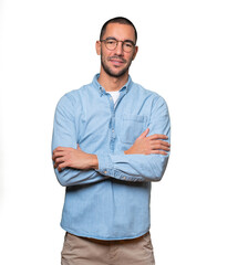 Satisfied young man with crossed arms gesture