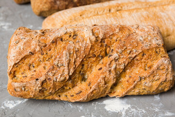 Homemade natural breads. Different kinds of fresh bread as background, perspective view with copy space