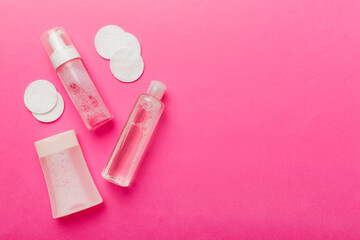 Micellar cleansing water and discs to remove cosmetics and cleanse the skin on colored background. Copy space top view