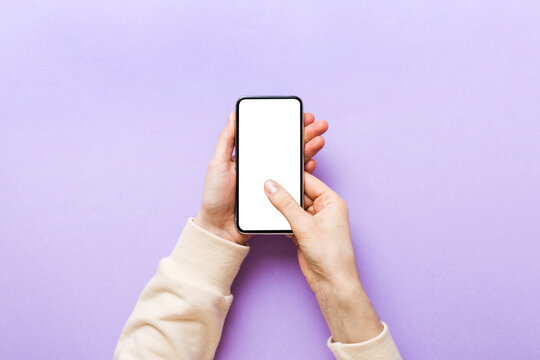 Top view of woman hands holding smart phone with blank copy space screen for your text message or information content. woman hand using phone white screen on top view