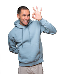 Amazed young man using his hands like a binoculars