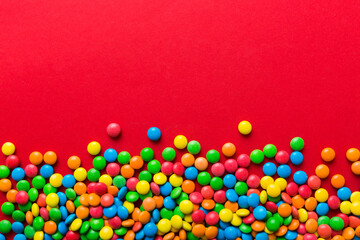 Mixed collection of colorful candy, on colored background. Flat lay, top view. frame of colorful chocolate coated candy