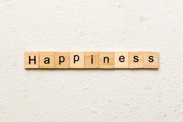 Happiness word written on wood block. Happiness text on table, concept