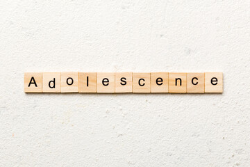 adolescence word written on wood block. adolescence text on table, concept