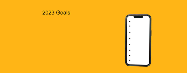 Yellow banner shot of a big phone with empty to do list for 2023 new year goals.