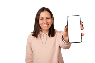 Young smiling woman is showing blank white phone screen at the camera. Studio shot with copy space.