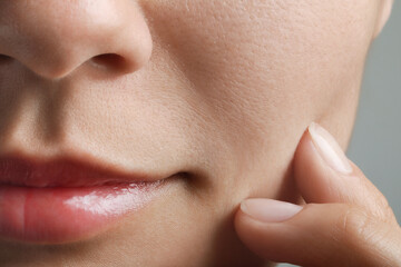 Closeup view of woman with healthy skin on light grey background