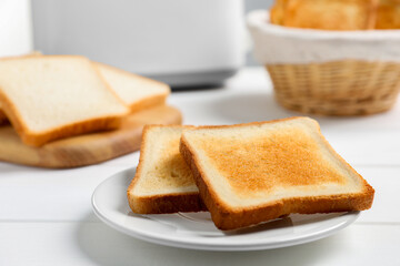 Fototapeta na wymiar Slices of tasty toasted bread on white wooden table, closeup