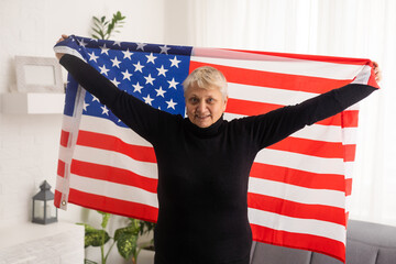 Elderly woman holding an American flag