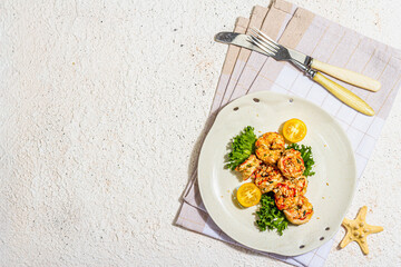 Grilled shrimp salad with lettuce, tomato cherries and spices on a plate. Fresh and healthy seafood