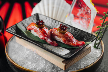 fresh sushi with caviar beautifully served, on ice in a restaurant plate