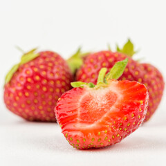 cut freshly picked natural strawberries from the garden. highlighted on white.
