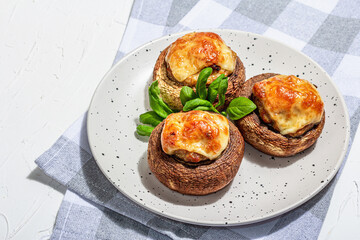 Baked stuffed mushroom caps ready for eating. Champignons, spices, vegetables, cheese